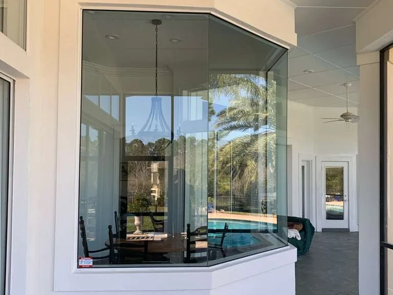An interior after, finished in white around a glass bay
