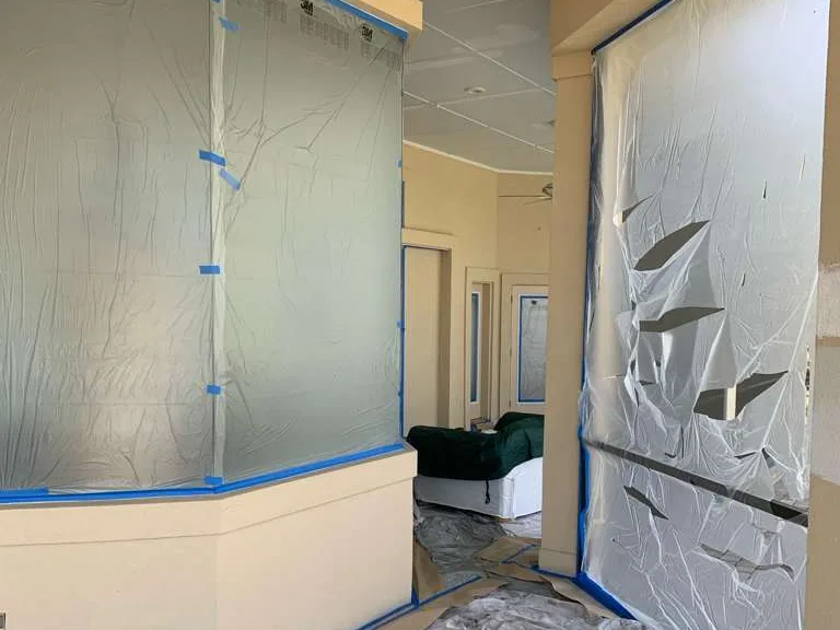 An interior before, sealed in plastic with the walls taped off