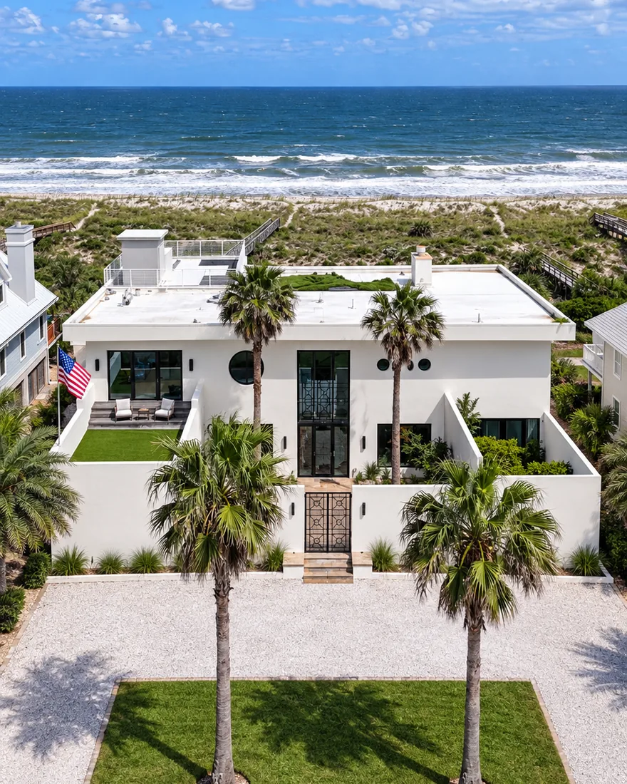 A white modern beach house behind the dunes on Amelia Island, with the Atlantic beyond