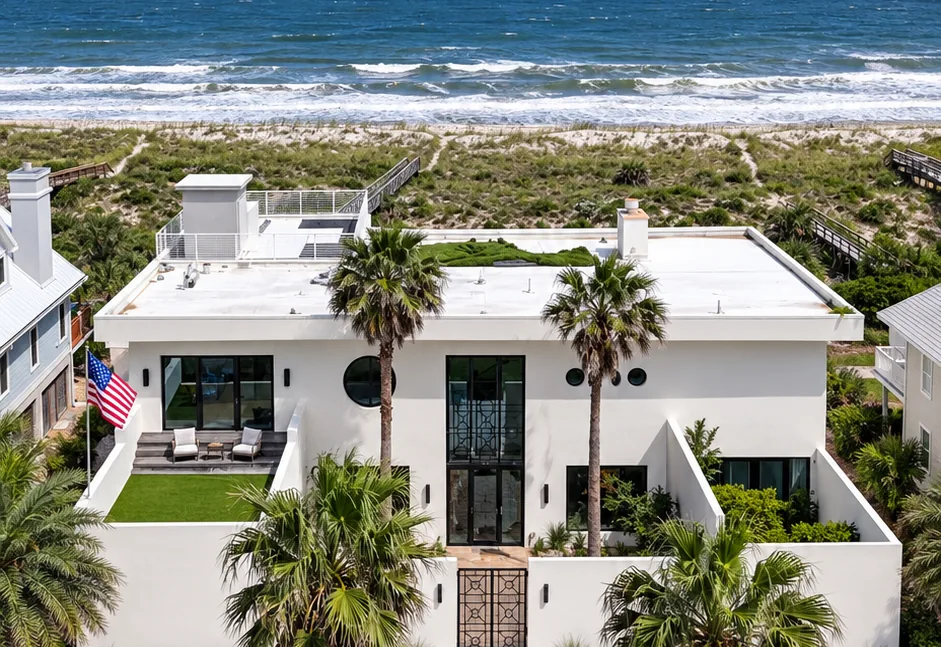 A white modern beach house behind the dunes on Amelia Island, with the Atlantic beyond